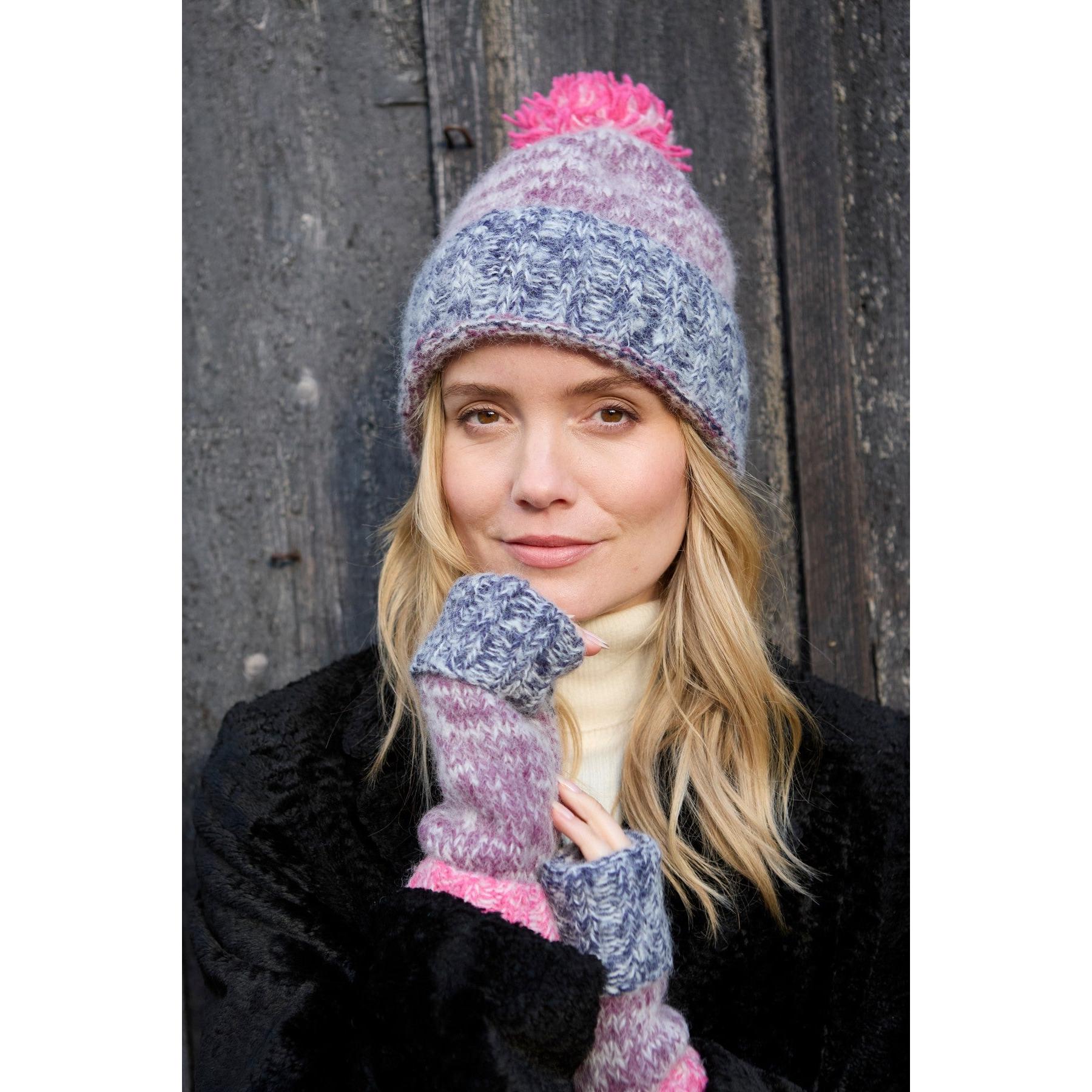 Pachamama Berlin purple bobble beanie with pink accents, knit texture, and matching fingerless gloves, cozy winter accessory.