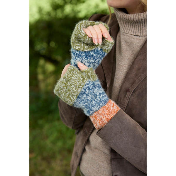 Handwarmer mittens in blue, green, and orange with a knitted pattern, held by a person outdoors.