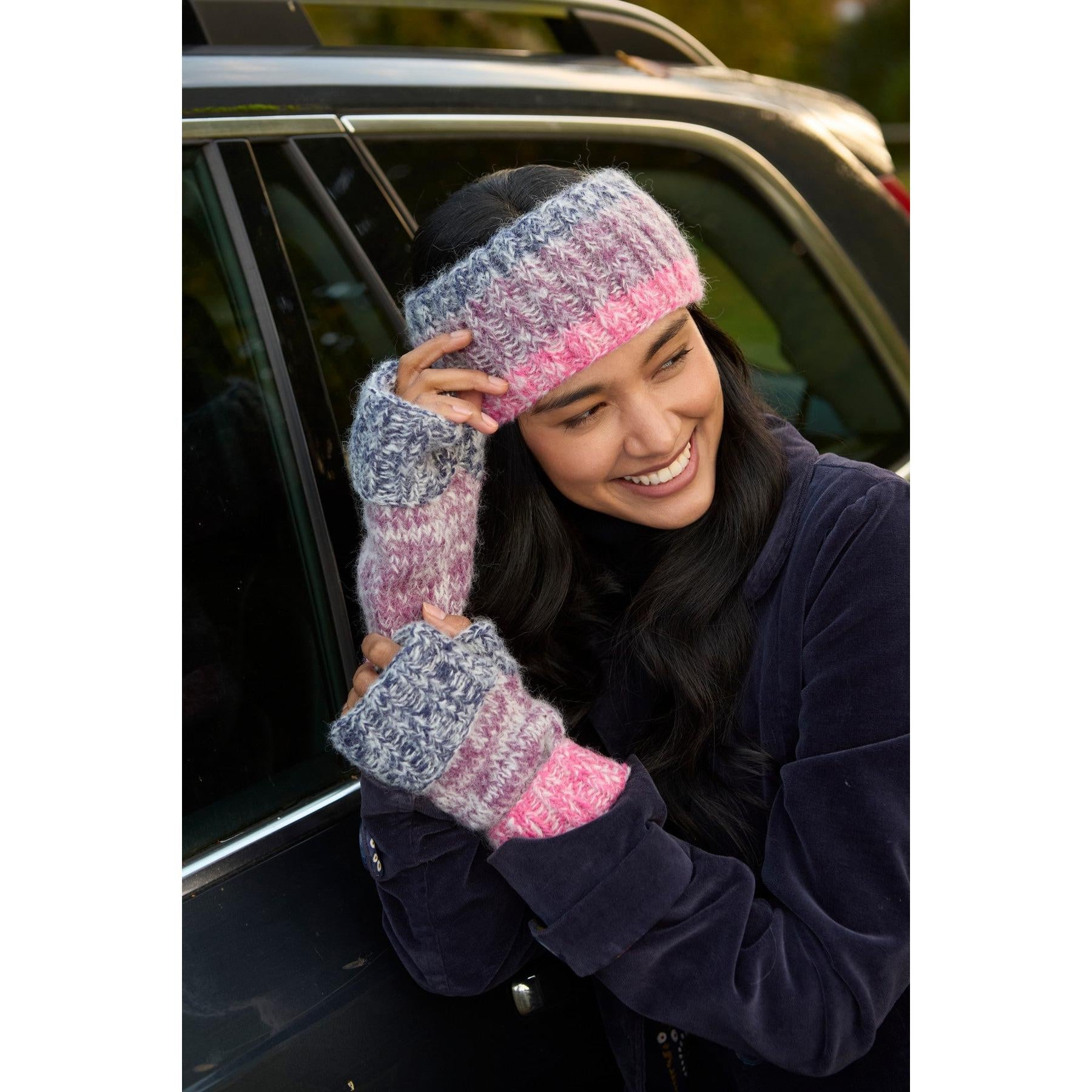 Woman wearing purple handwarmer and headband, outdoor autumn scene, Pachamama Berlin product image.