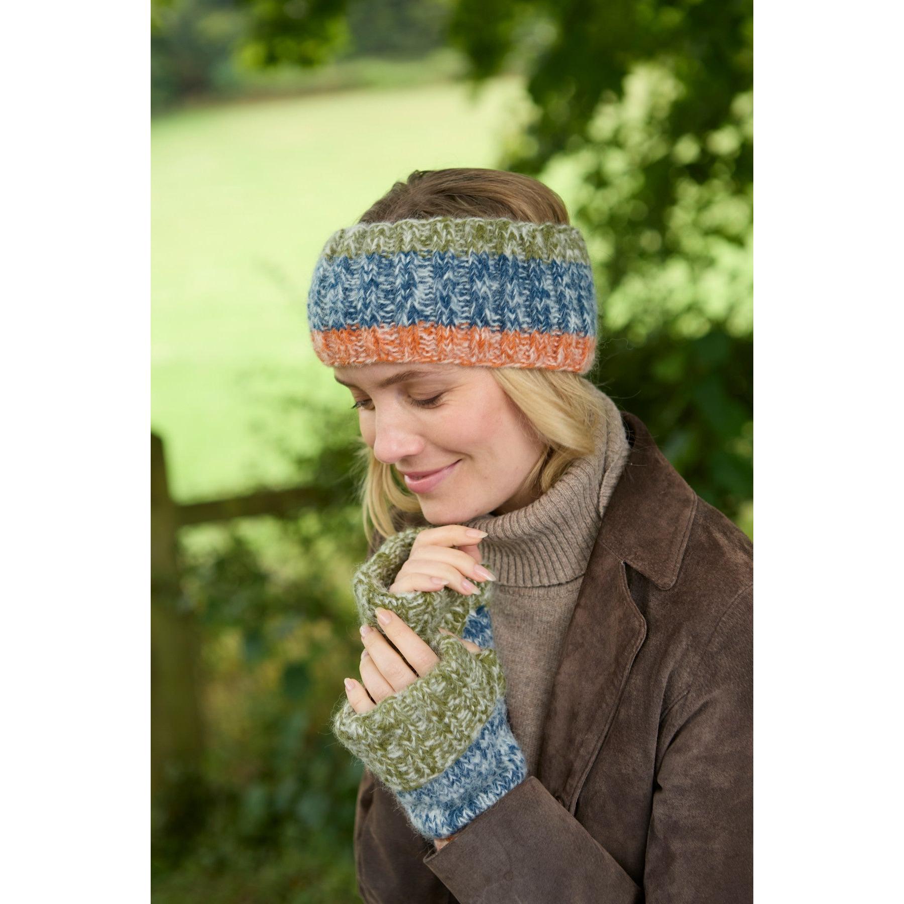Women wearing blue, orange, and green knitted headband and mittens, outdoors during fall or winter, casual style.
