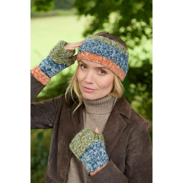 Woman wearing blue, green, and orange Pachamama Berlin headband and gloves outdoors, casual fall fashion, natural background.