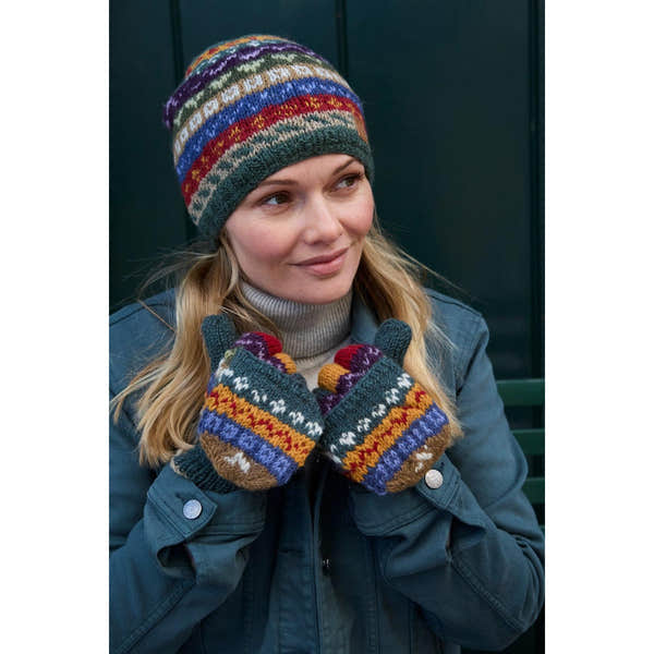 Pachamama Elveden beanie and colorful patterned knit gloves worn by woman outdoors, cozy winter accessories, stylish cold-weather wear.