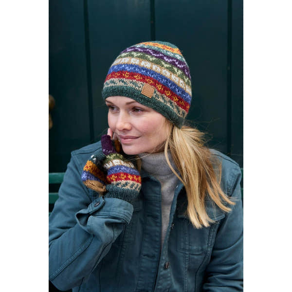 Pachamama Elveden beanie and matching gloves with colorful, patterned knit design on woman outdoors.