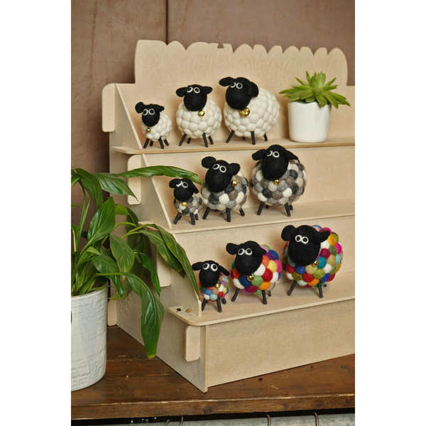 Handmade Pachamama Helen The Herding Bobbly Lamb plush toys with sheep designs, black heads, colorful wool bodies, and small gold bells.