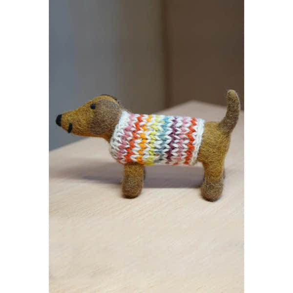 Felt dachshund plush toy wearing a colorful knitted sweater, branded Pachamama Hoxton Harry the Dachshund.