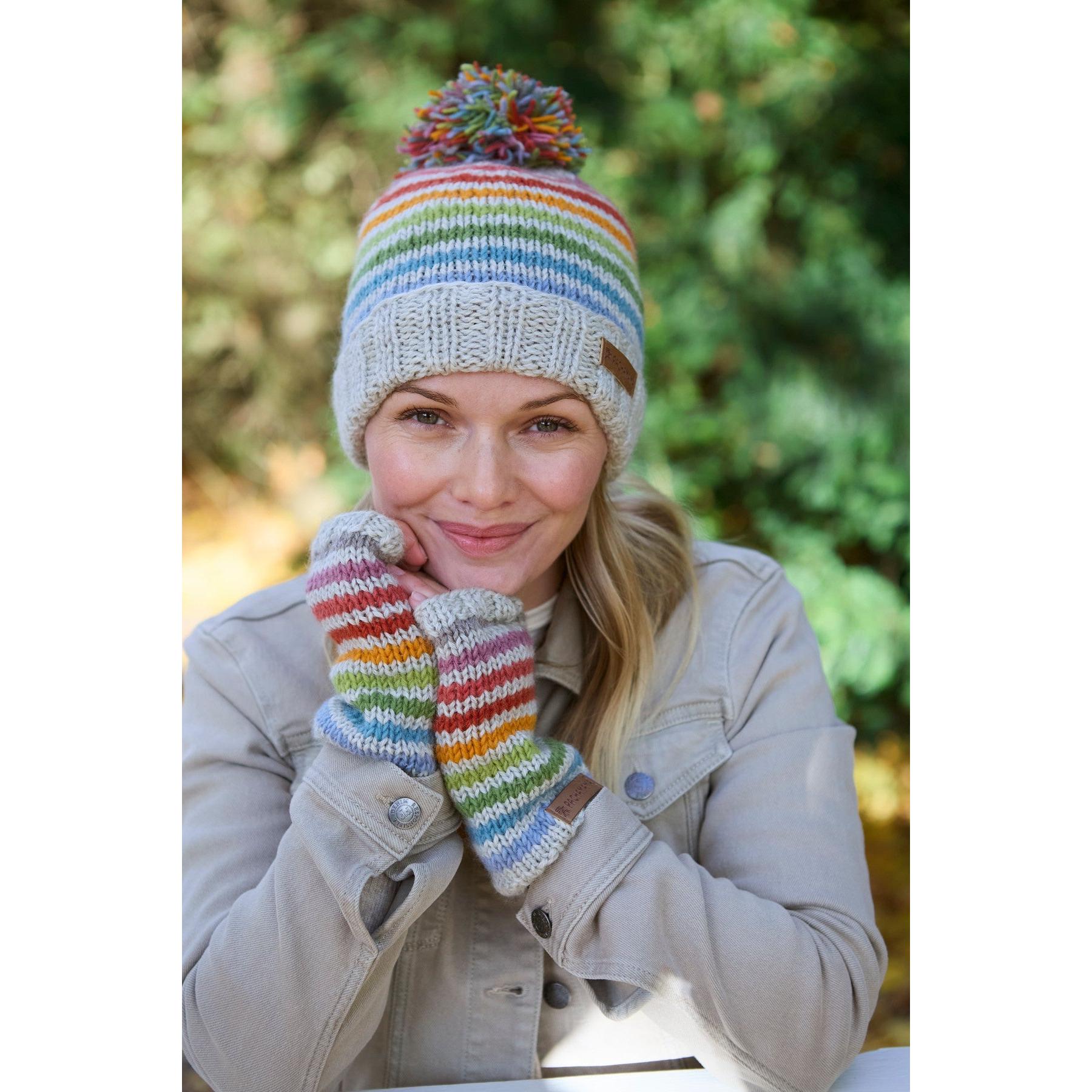 Pachamama Hoxton Stripe Bobble Beanie and matching gloves in colorful rainbow stripes, made of pure Merino wool.
