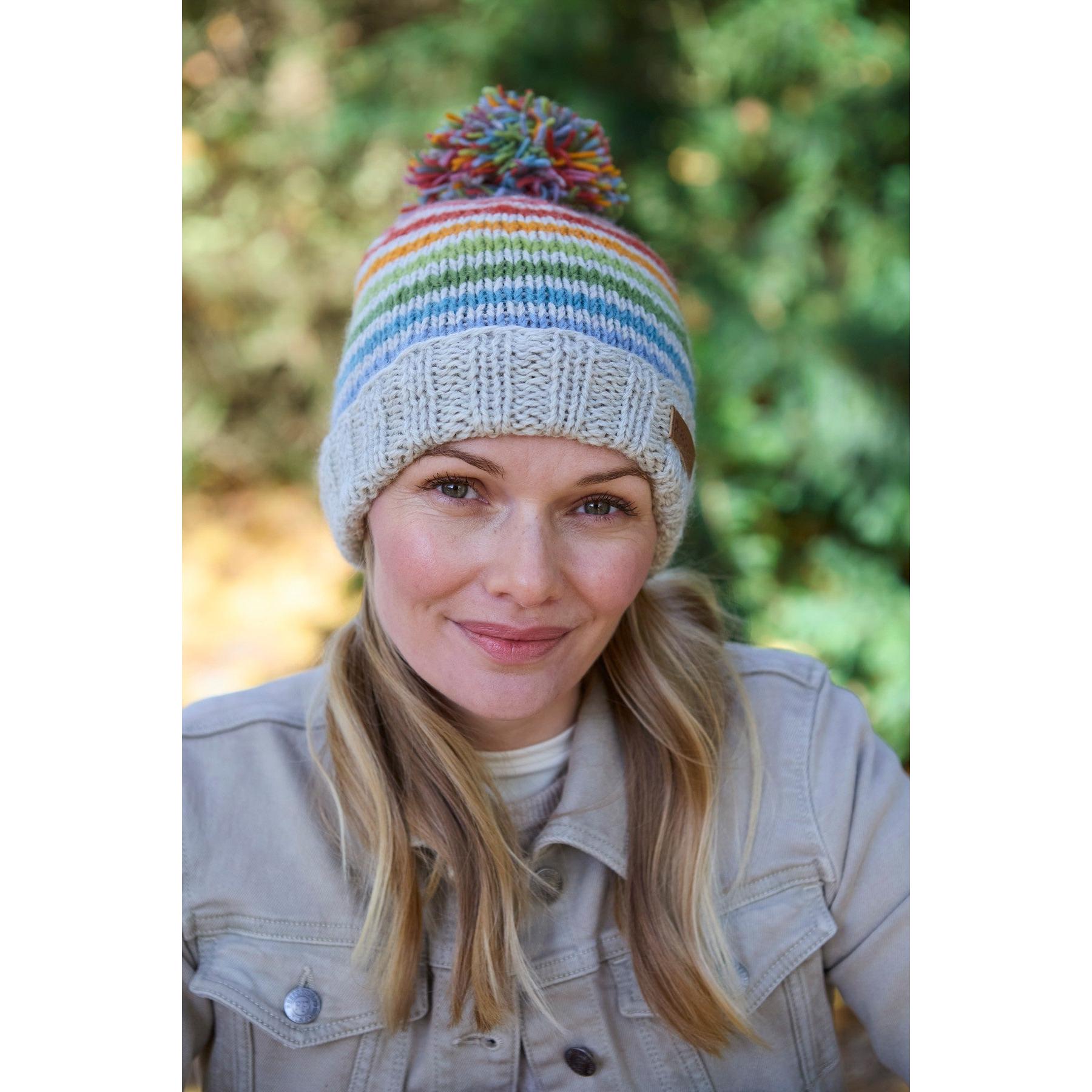 Pachamama Hoxton Stripe Bobble Beanie in pure Merino wool, featuring colorful rainbow stripes and a pom-pom on top.