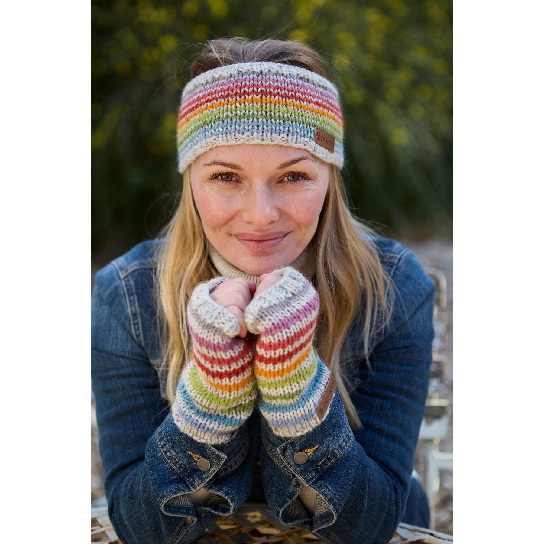 Pachamama Hoxton Stripe Handwarmer set in colorful, striped pure merino wool, worn by a woman outdoors.