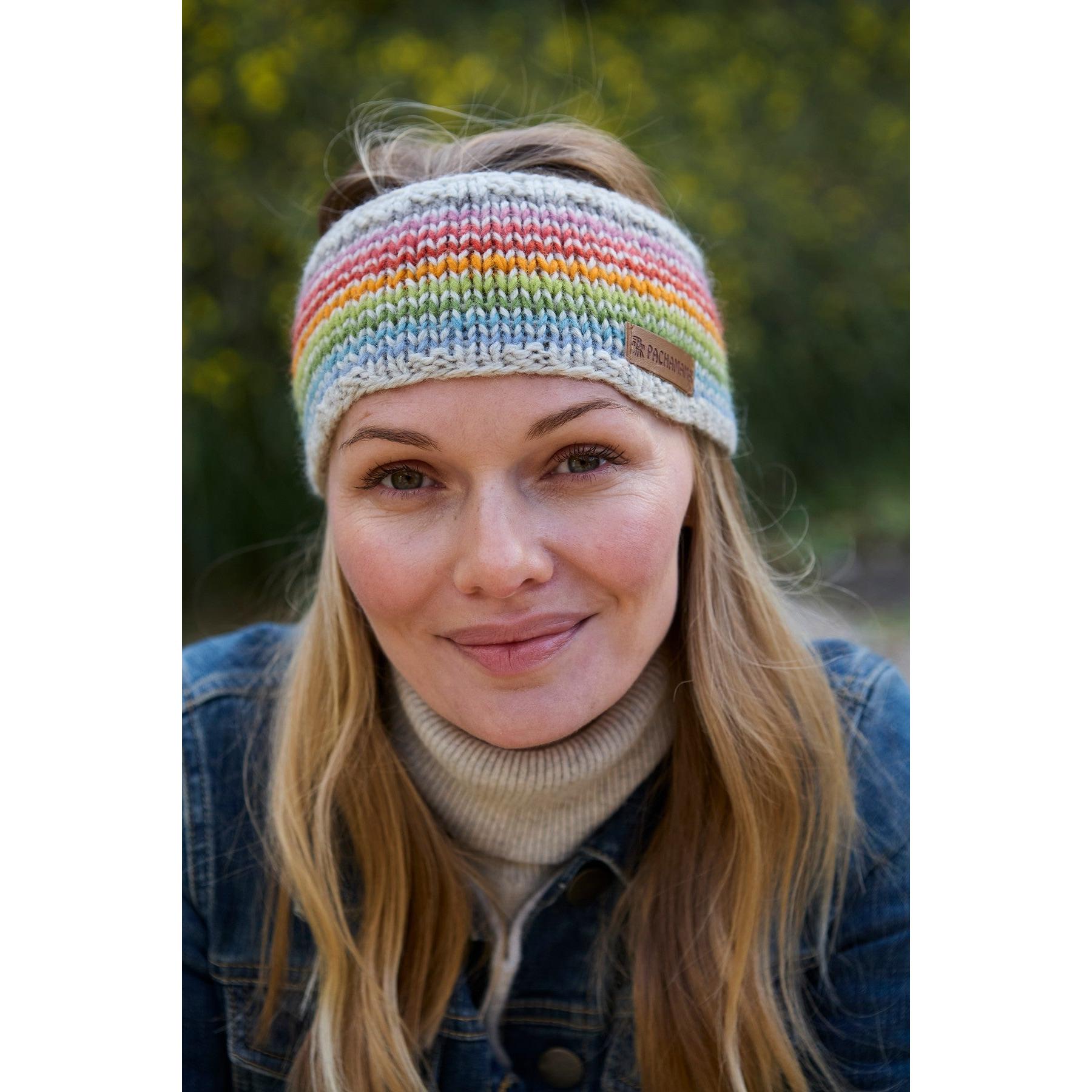 Woman wearing Pachamama Hoxton Stripe Headband in multicolor Merino wool, outdoor setting, stylish, cozy winter accessory.
