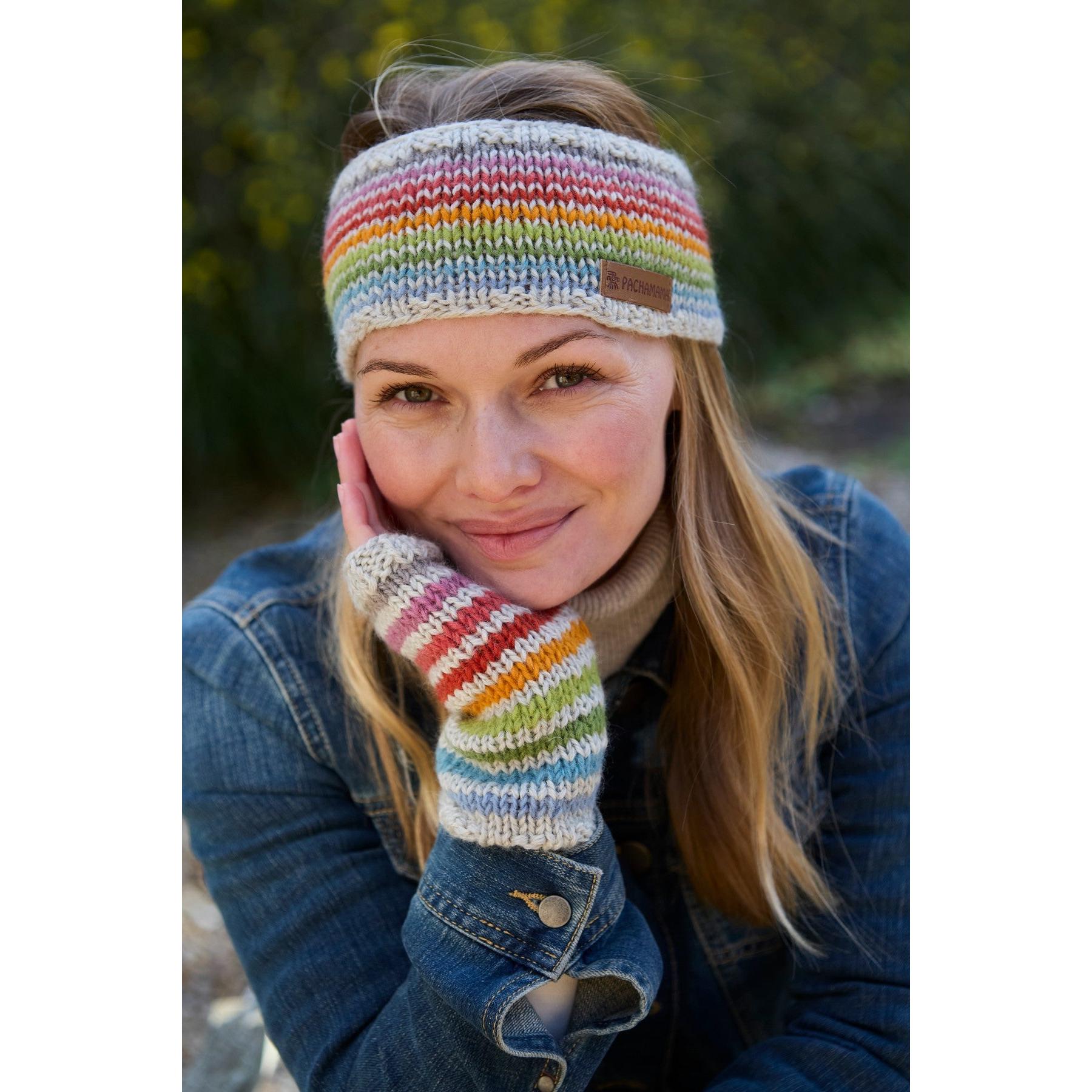 Pachamama Hoxton Stripe Headband in pure Merino wool, featuring colorful striped design, worn by smiling woman outdoors.