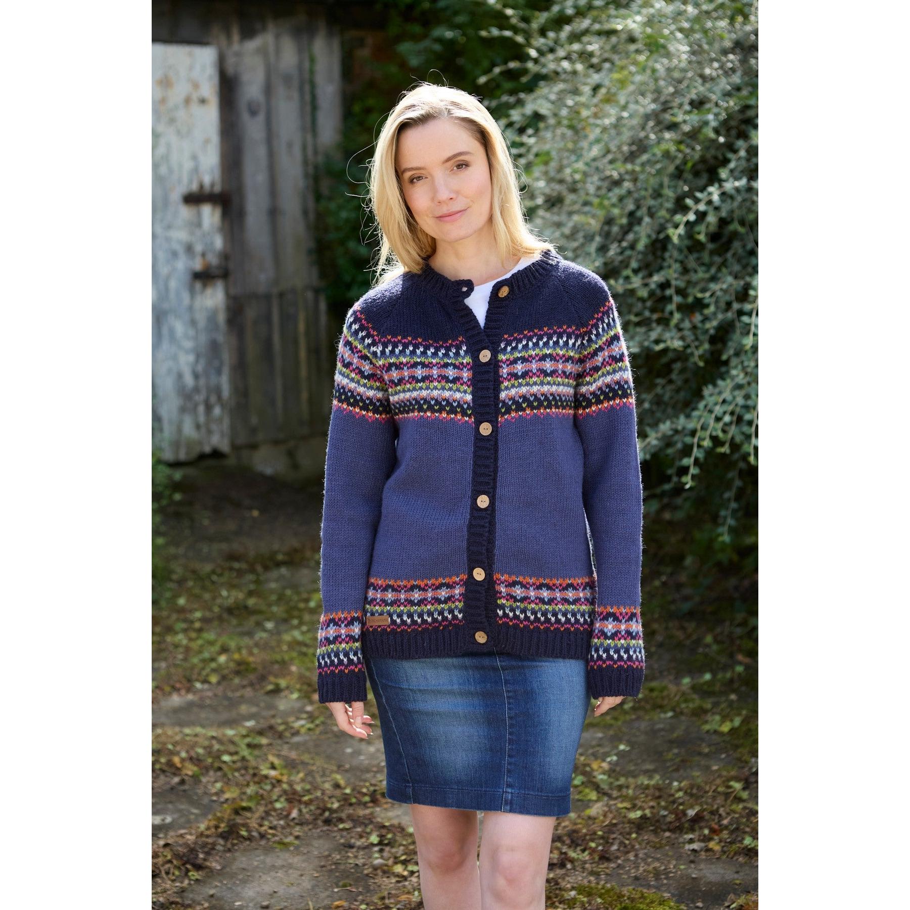 Pachamama Iona Cardigan Denim, women’s navy and multicolor knit cardigan with button closure, outdoor setting.