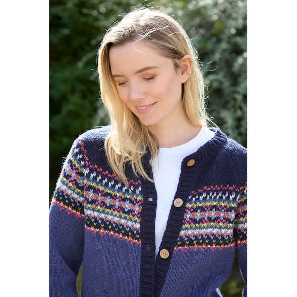 Pachamama Iona Cardigan Denim, navy knit with colorful Fair Isle pattern, wooden buttons, women's casual sweater outdoors.
