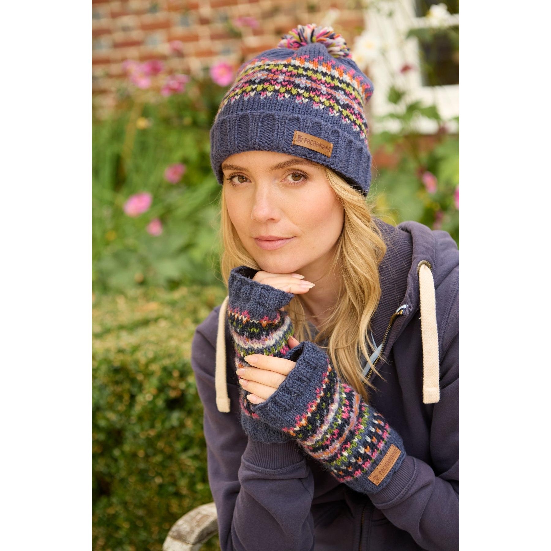 Pachamama Iona Handwarmer Denim, knitted fingerless gloves and beanie set with colorful patterns and a leather logo patch.