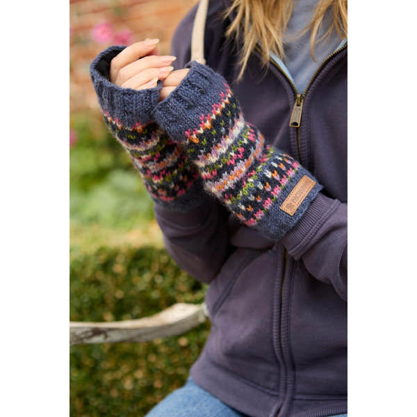 Pachamama Iona Handwarmer Denim, cozy knitted gloves with colorful patterns, worn outdoors in fall.