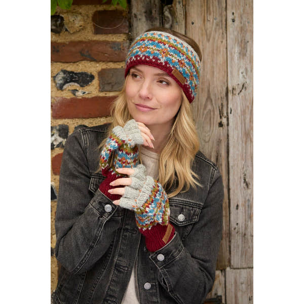 Woman wearing a burgundy Pachamama Iona headband with colorful knit pattern, matching gloves, and a black denim jacket.
