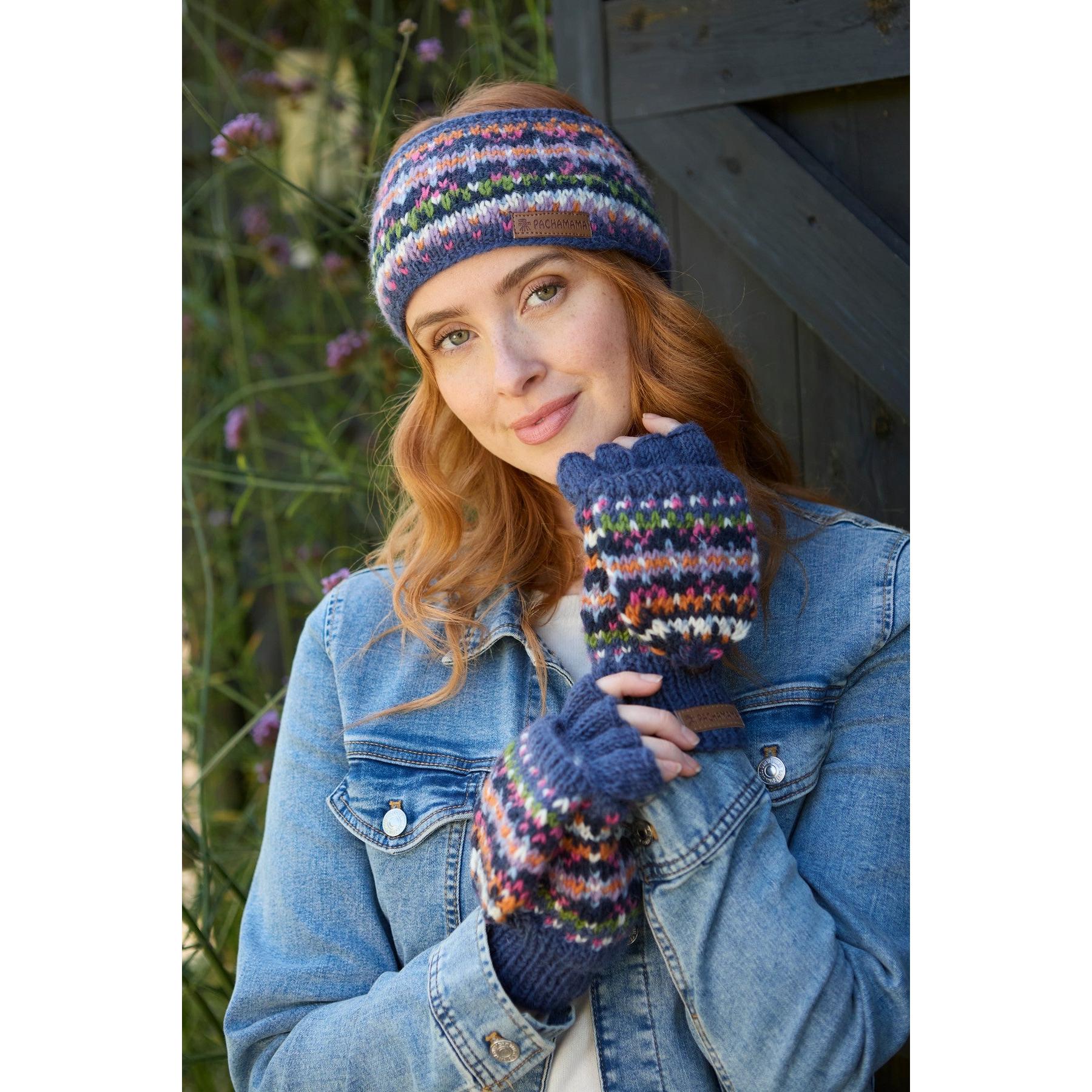 Pachamama Iona denim headband and fingerless gloves set with colorful knit pattern, worn by a woman outdoors.