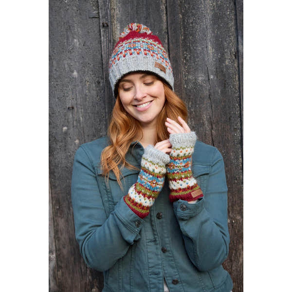 Pachamama Iona Roll Back Bobble Beanie in Burgundy with colorful knit pattern and pom-pom, paired with matching patterned gloves.
