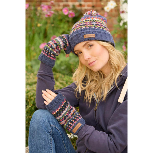 Pachamama Iona Roll Back Bobble Beanie Denim with colorful patterns, knit design, and leather logo patch, worn with matching mittens.