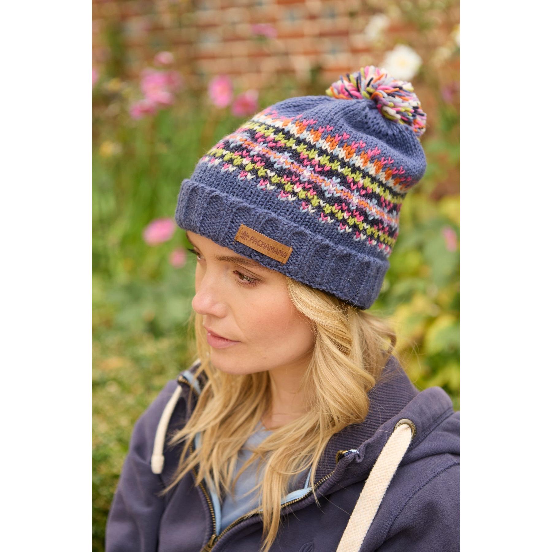 Pachamama Iona Roll Back Bobble Beanie in denim with colorful patterned knit and pom pom detail.