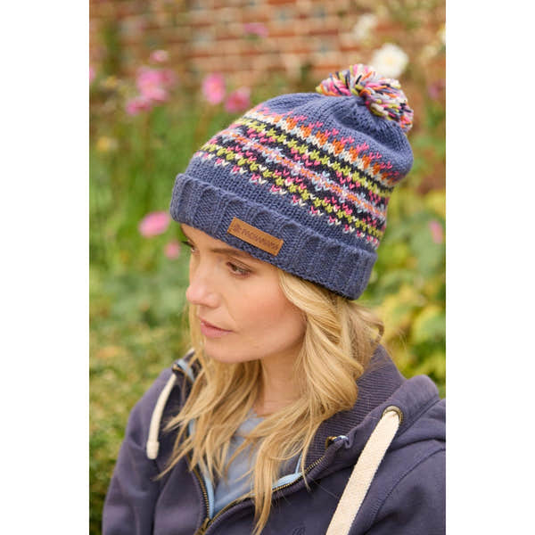 Pachamama Iona Roll Back Bobble Beanie in denim with colorful patterned knit and pom pom detail.
