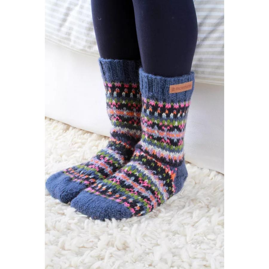 Pachamama Iona sofa socks in denim with colorful Fair Isle pattern, cozy knit design, and leather logo tag.