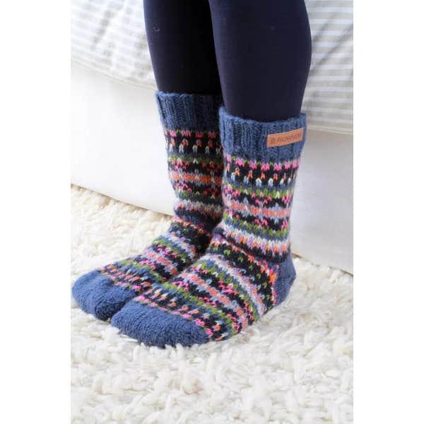Pachamama Iona sofa socks in denim with colorful Fair Isle pattern, cozy knit design, and leather logo tag.