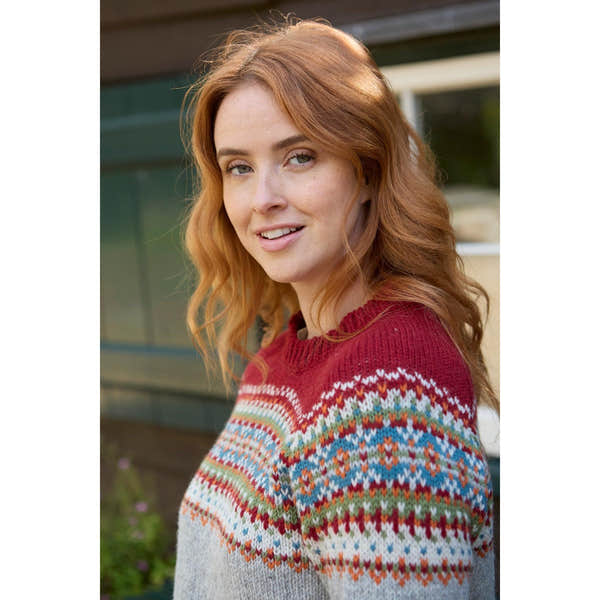 Pachamama Iona Sweater Burgundy with colorful patterned yoke, woman outdoors, cozy knitwear, fall fashion, stylish and warm.
