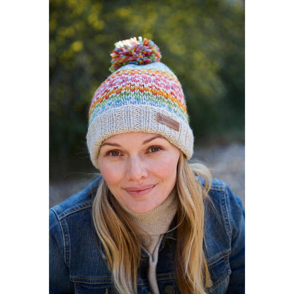 Pachamama Killarney Bobble Beanie in Oatmeal with colorful stripes and pom-pom, made of pure merino wool.