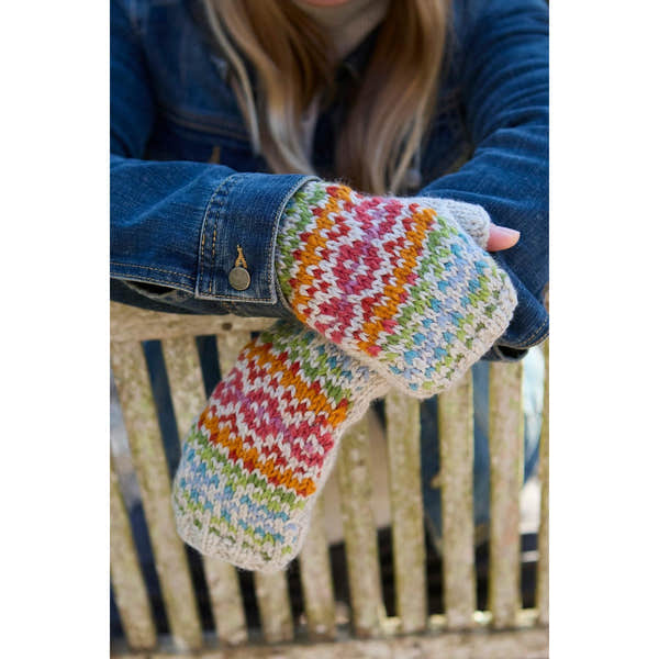 Pachamama Killarney Pure Merino Handwarmer in Oatmeal with colorful striped knit pattern, worn over denim jacket.