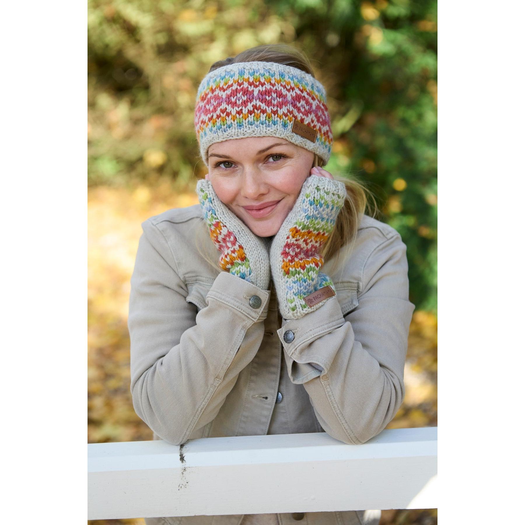 Woman wearing Pachamama Killarney Pure Merino oatmeal-colored headband and matching gloves, outdoor fall setting.