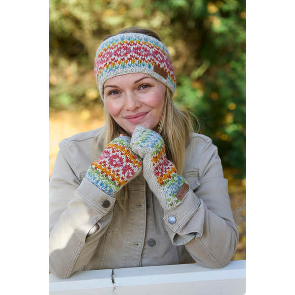 Woman wearing colorful knitted merino wool hat and mittens, holding her chin outdoors, autumn background, cozy winter accessories.