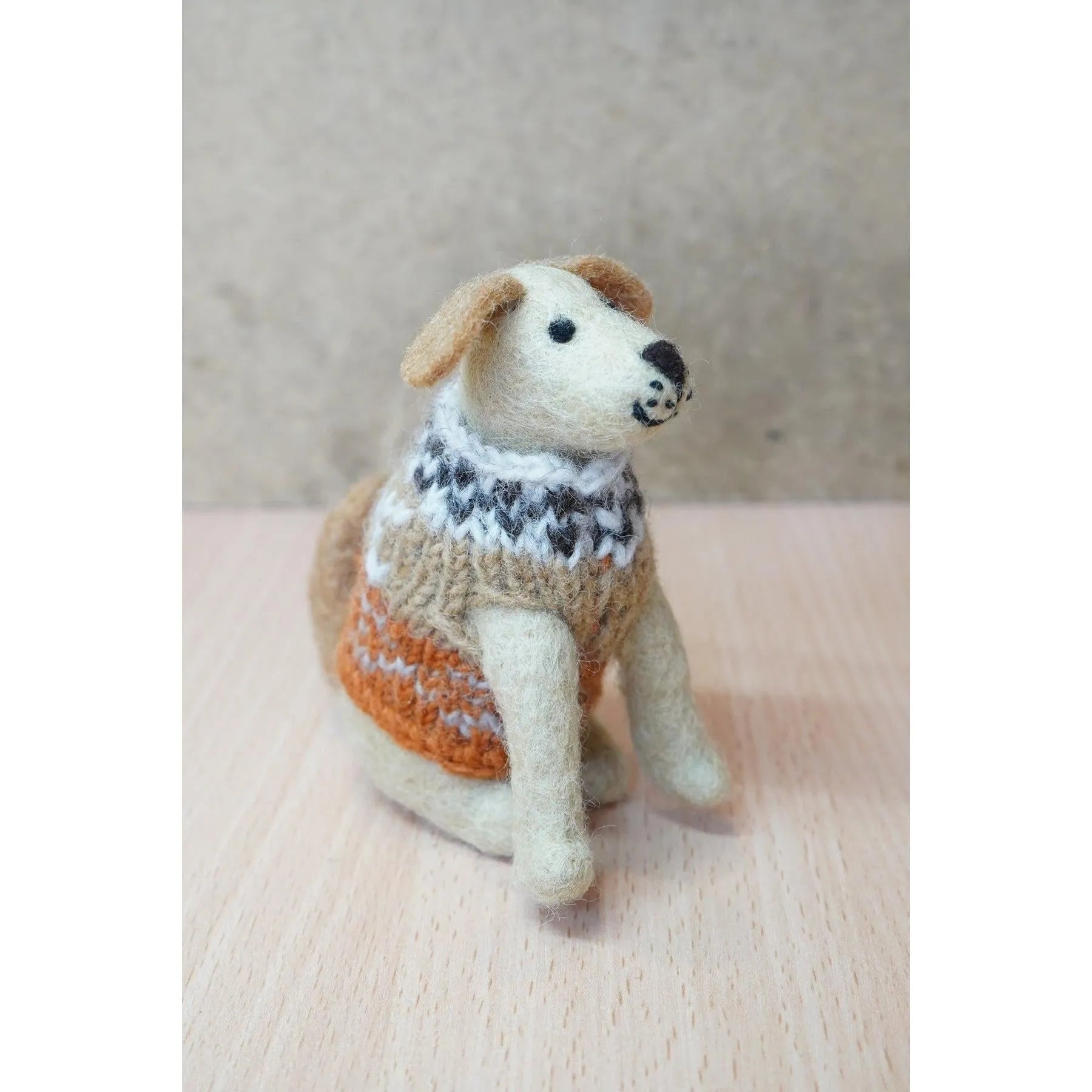 Felted Labrador dog figurine wearing a cozy, multicolored sweater, representing Pachamama Laura, handcrafted and detailed.