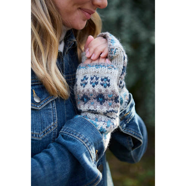 Pachamama Loch Fyne Handwarmer in blue, pure merino wool with traditional knit pattern, worn by a woman outdoors.