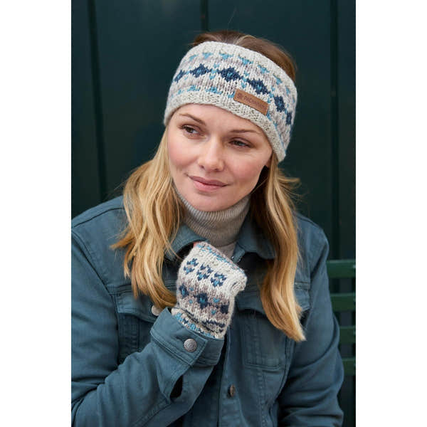 Woman wearing blue Pachamama Loch Fyne Pure Merino headband with a patterned knit design.