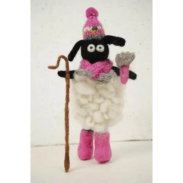 Pachamama Shearing Sheila handmade felt sheep figurine with pink hat, scarf, boots, and wool coat, holding a walking stick and heart-shaped object.