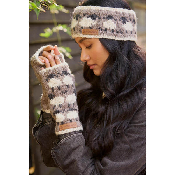 Woman wearing Pachamama Merino sheep handwarmer and headband with mushroom pattern, cozy wool accessories for cold weather.