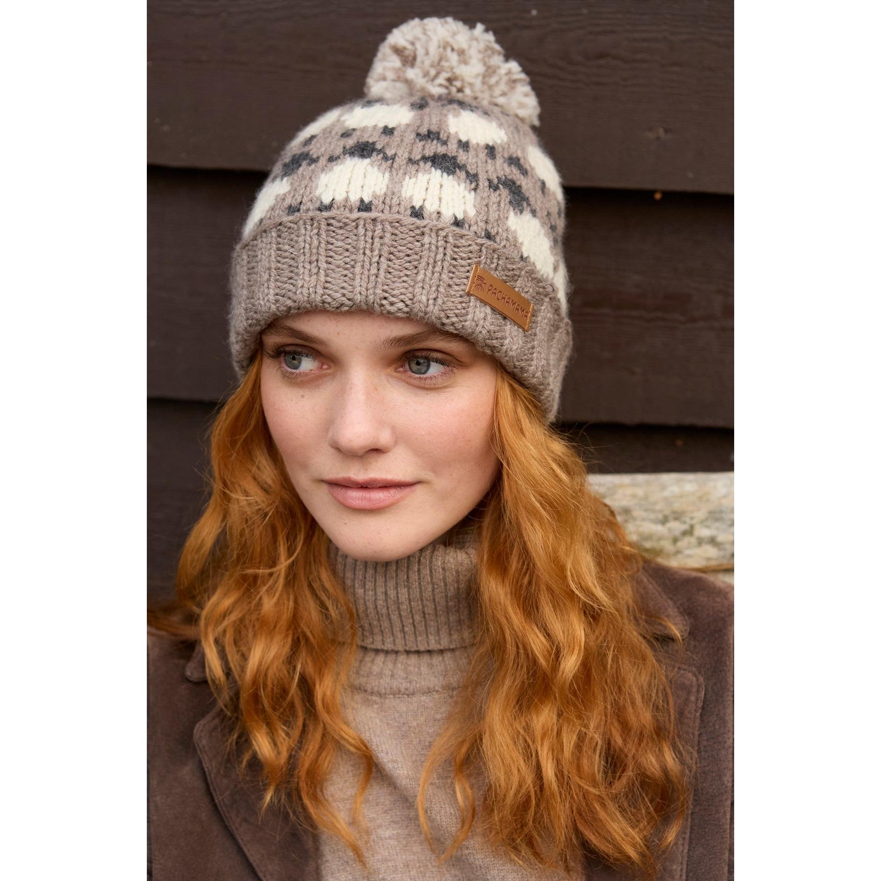 Pachamama Merino sheep roll-back beanie with mushroom pattern, cozy knit, and pom-pom, perfect for cold weather.