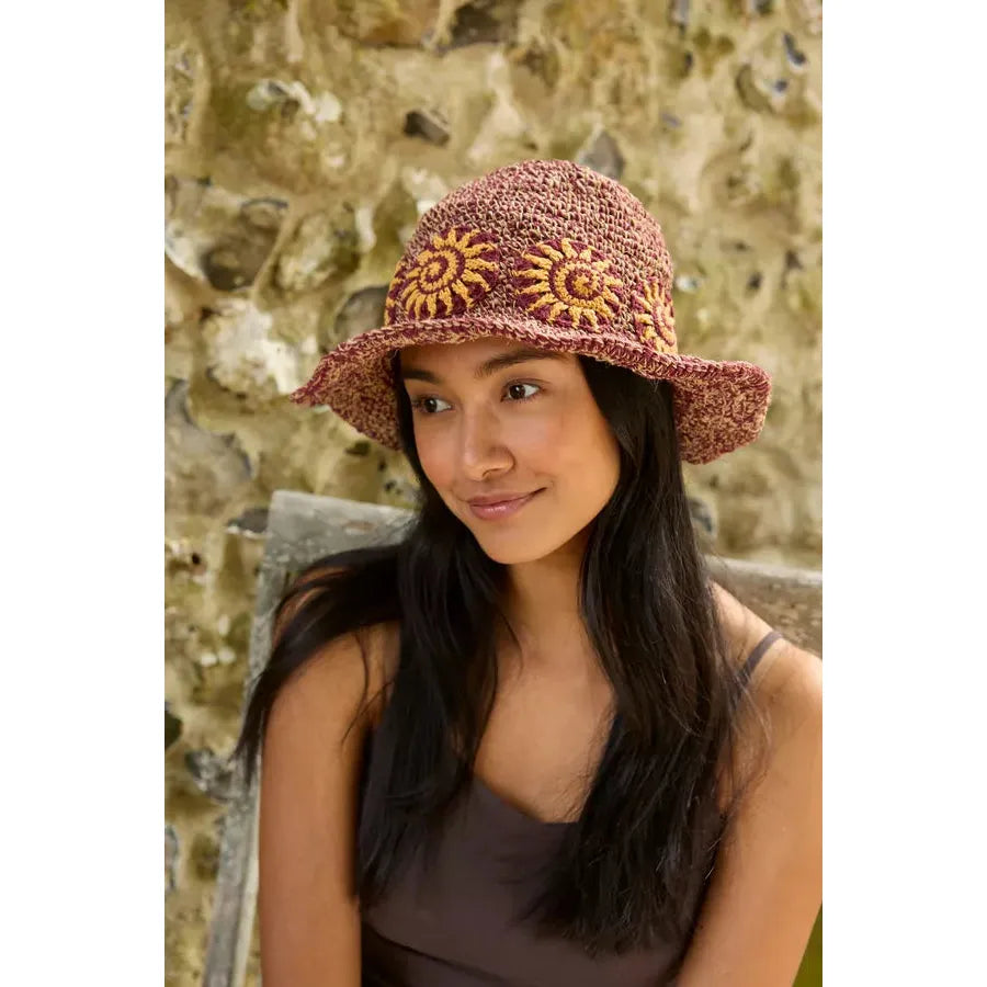 Pachamama Sunshine hemp and cotton sun hat in burgundy with embroidered yellow sun designs, stylish and eco-friendly accessory.