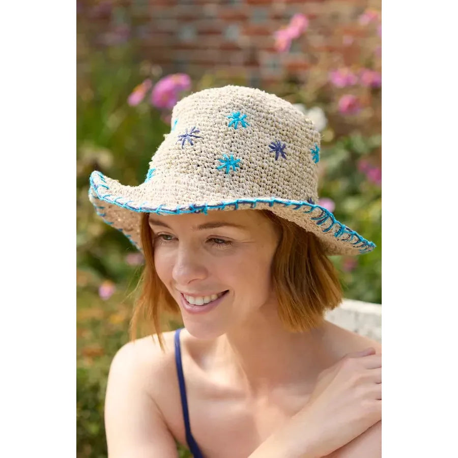 Pachamama Wildflower Hemp Cotton Hat in Blue with embroidered floral details, lightweight and sun-protective for outdoor wear.