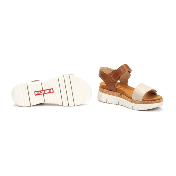 Women's beige leather sandals with touch fastening and cork soles, stylish and comfortable footwear for summer.