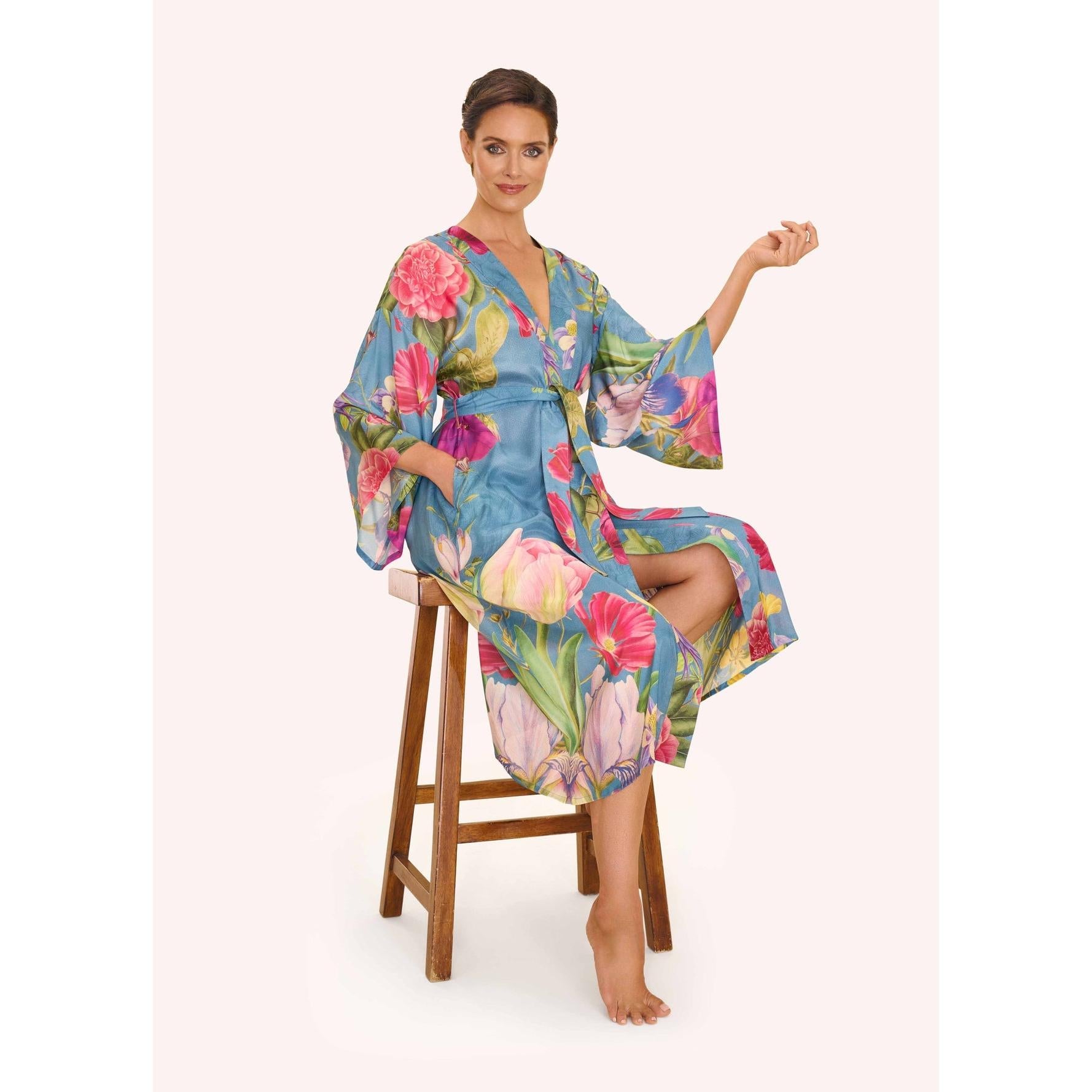 Women's floral study denim kimono gown with a relaxed fit, vibrant flower pattern, and wide sleeves.