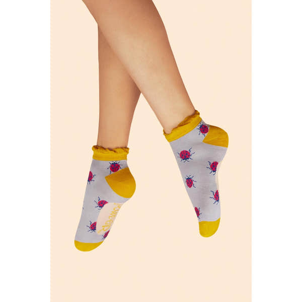 Powder Lovely Ladybirds lilac trainer socks with yellow accents, featuring ladybird print and ruffled ankle edges.