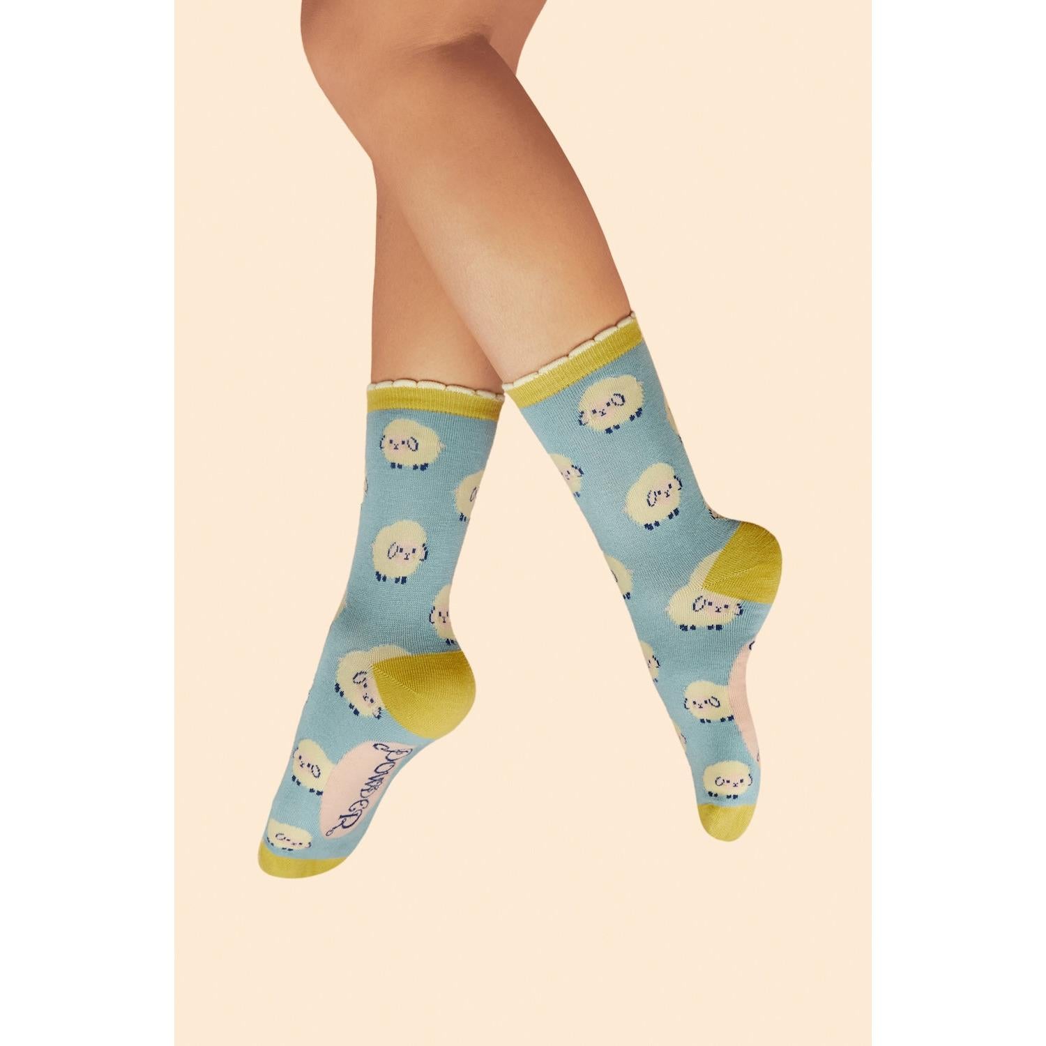 Ice blue powder marshmallow sheep ladies ankle socks with yellow toes and accents, cute cartoon sheep pattern.