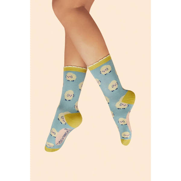 Ice blue powder marshmallow sheep ladies ankle socks with yellow toes and accents, cute cartoon sheep pattern.