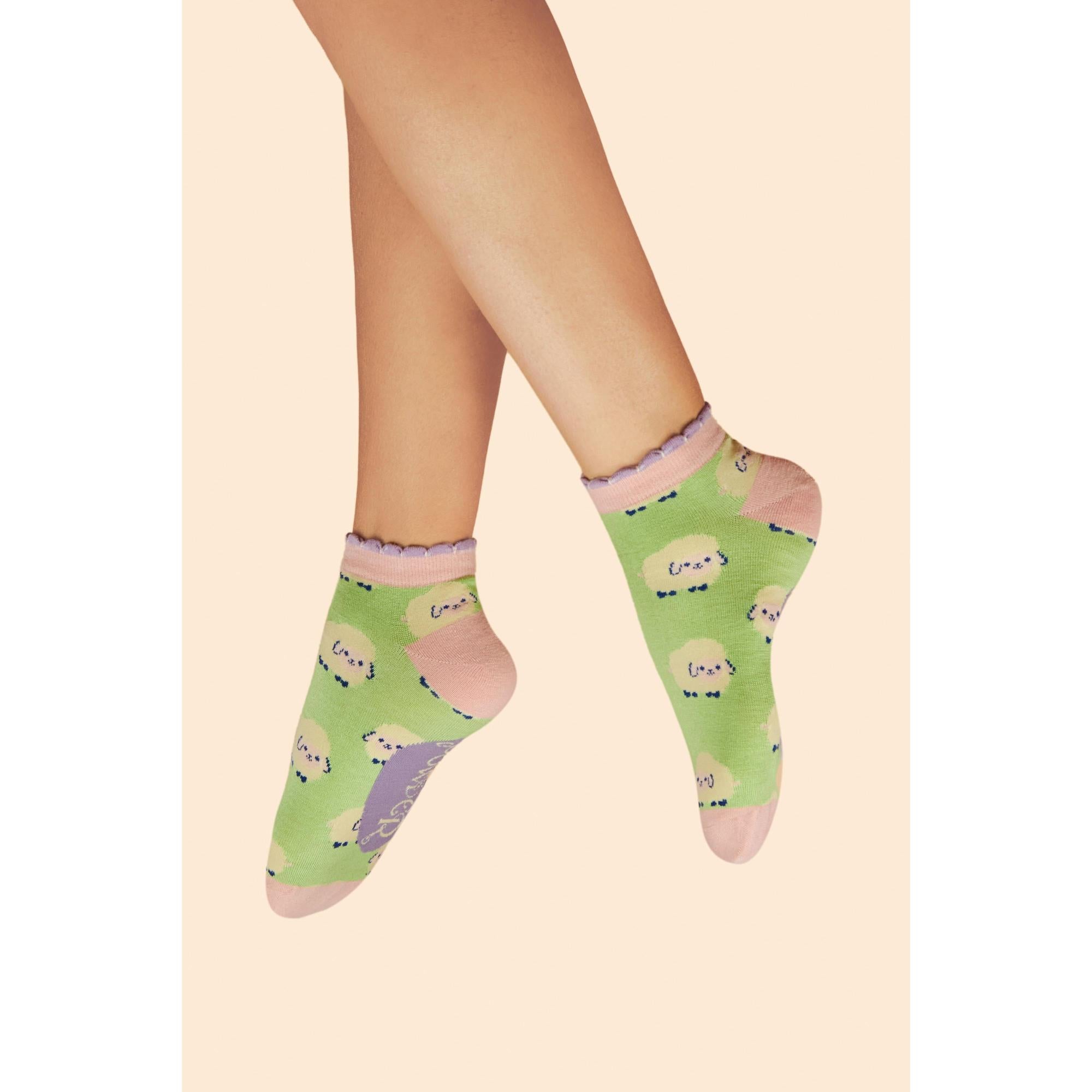 Powder marshmallow sheep ladies trainer socks in mint with pink heel and toe, adorable sheep pattern, and scalloped ankle details.