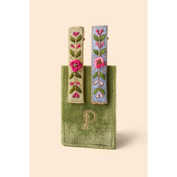 Powder Narrow Jewelled Hair Bar with mint and cornflower blue floral vines, featuring pink and green embroidery, displayed on a green velvet pouch.