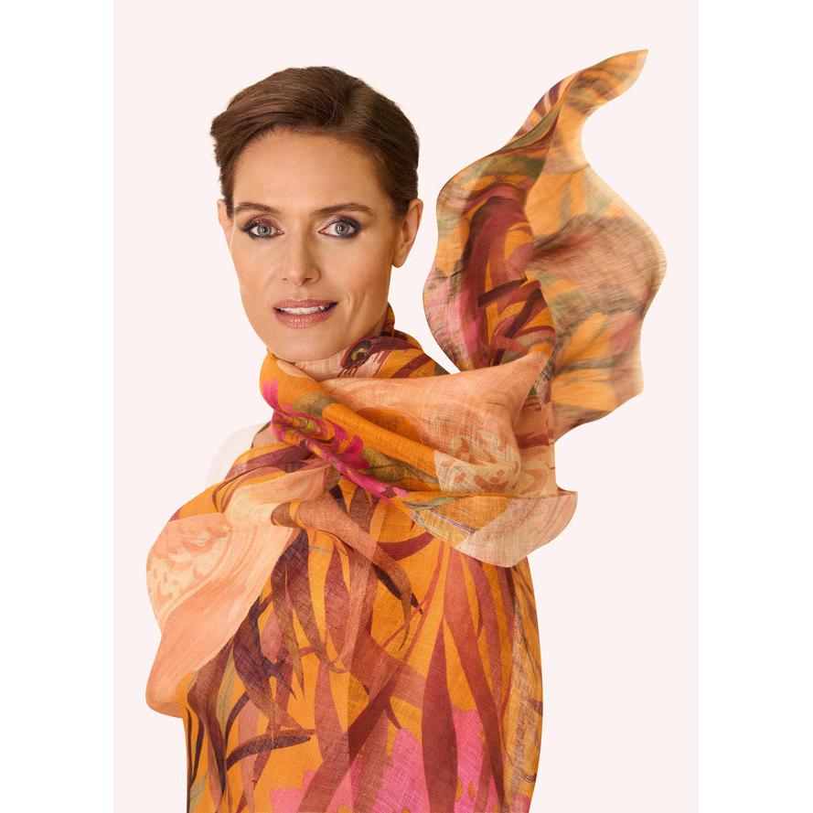 Powder Oriental Crane linen and cotton blend scarf featuring colorful botanical print, styled on a woman with short hair.