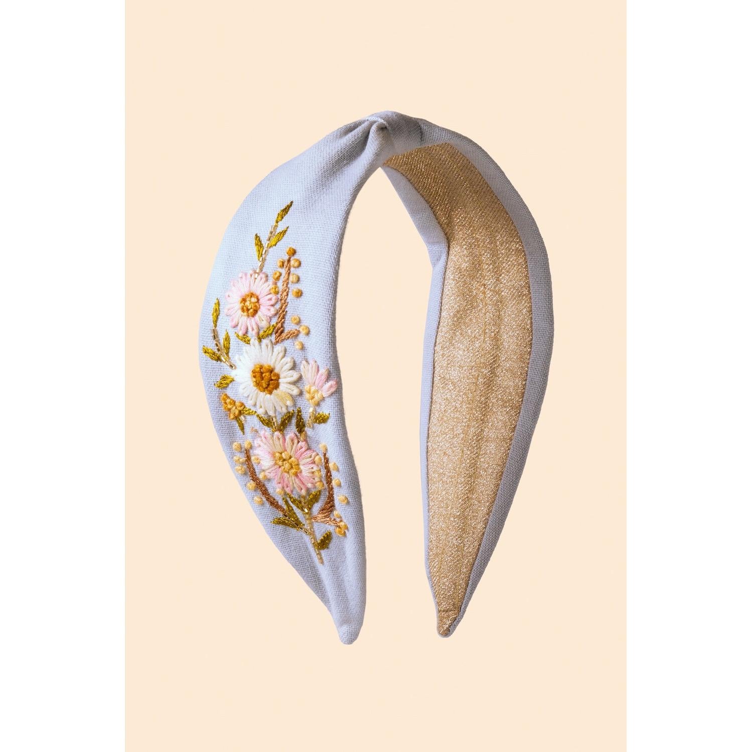 Powder blue embroidered headband with floral embroidery and gold accents, featuring a soft gold interior lining.