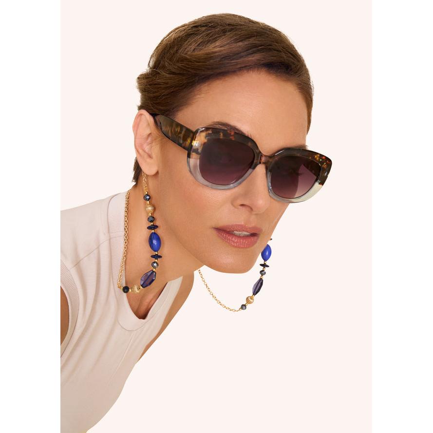 Powder Polina Ltd Edition sunglasses with tortoiseshell and aqua frames, dark gradient lenses, and stylish jewelry.
