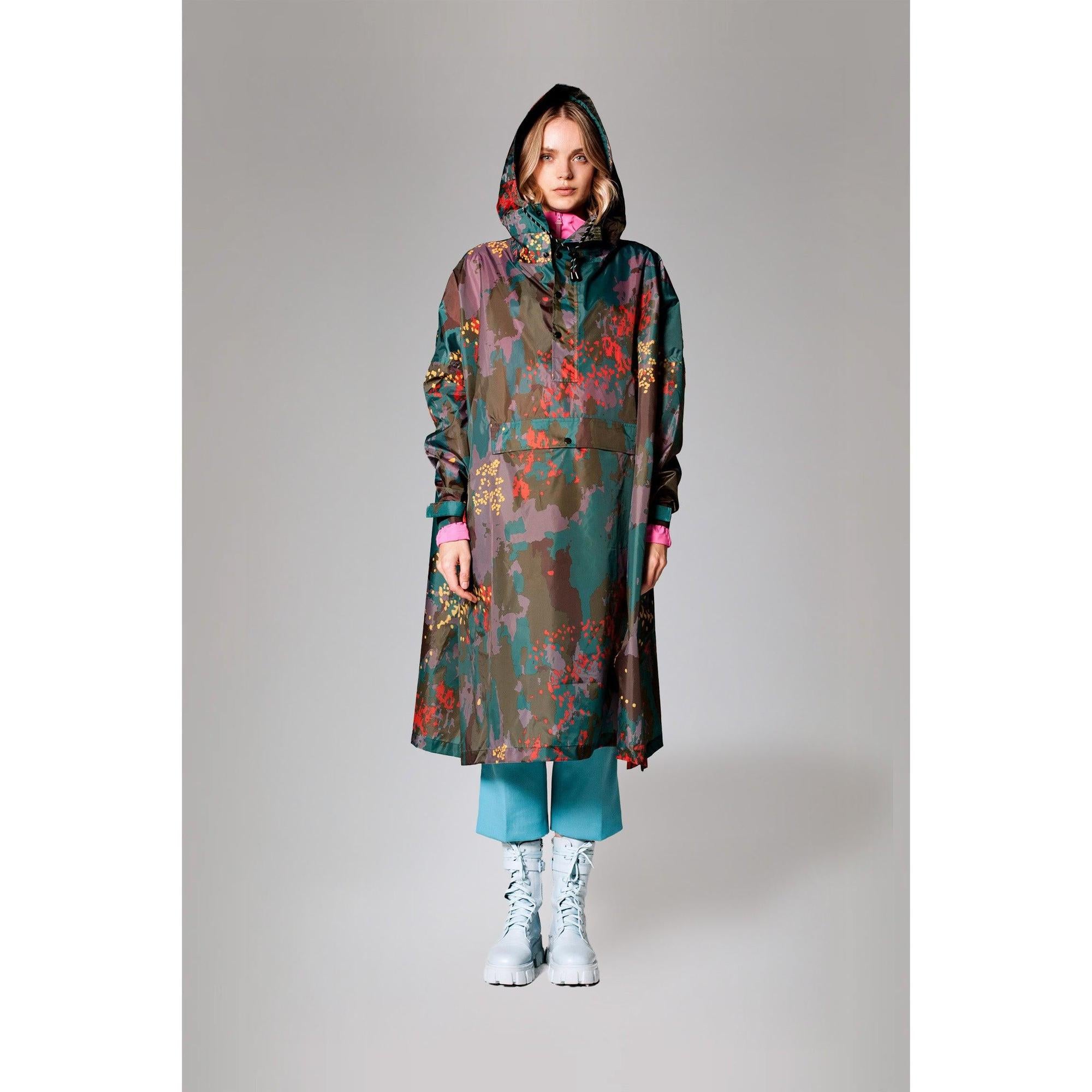 Rainkiss Digi Forest Camo rain poncho with hood, colorful abstract camouflage design, lightweight waterproof fabric, full-length coverage.